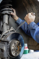 mechanic fixes brakes