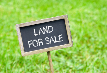 Land for Sale - chalkboard on green grass background