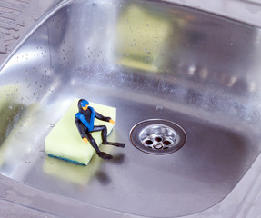 plasticine diver sitting in the kitchen sink