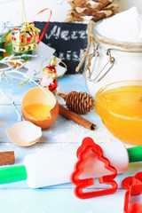 Christmas decoration tools for baking cookies form a rolling pin on a light wooden background 