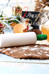 rolled out dough for gingerbread Christmas homemade cakes on a light wooden background selective soft focus rustic style