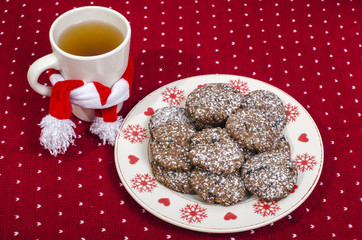 Christmas chocolate chip cookies.Delicious home made cookies on a festive plate with a hot cup of tea.