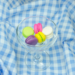colorful macaroons on checkered tablecloth