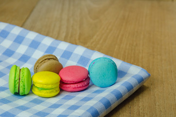 colorful macaroons on checkered tablecloth