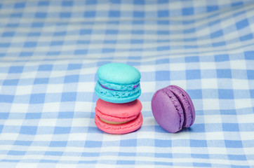 colorful macaroons on checkered tablecloth