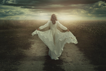 Fototapeta na wymiar Woman running free in a desolate land