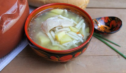 
Rustic noodles soup with chicken and potatoes in a traditional Russian dishes
