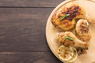 Grilled chicken lag and chicken drumstick on wooden background