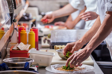 male cooks preparing meals