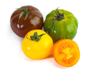 Different colors tomatos, Solanum lycopersicum, on white backgroung