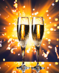 champagne glass against sparkler background