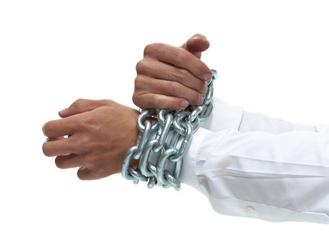 Businessman's hands chained together tightly