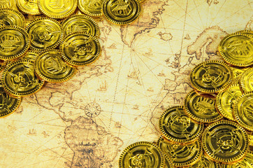 pirate golden coin on a old world map