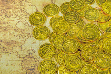 pirate golden coin on a old world map
