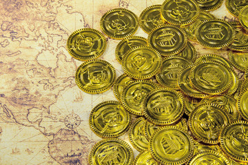 pirate golden coin on a old world map
