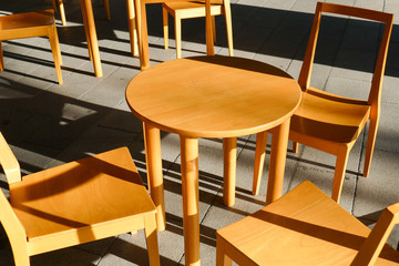 wooden chair and table with sunlight and shadow