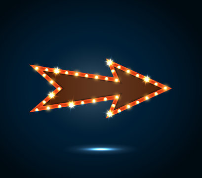An arrow sign with light bulbs on blue background