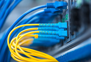 Fiber Optic cables connected to an optic ports and Network cable