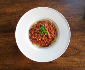 Italian spaghetti with a meat sauce on a white plate