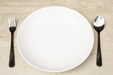 spoon, fork and empty dish on a tile surface - Empty Dish  (ready for your design)