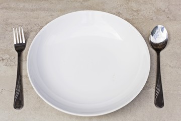 spoon, fork and empty dish on a tile surface - Empty Dish  (ready for your design)