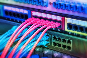 Naklejka premium network cables and hub closeup with fiber optical background