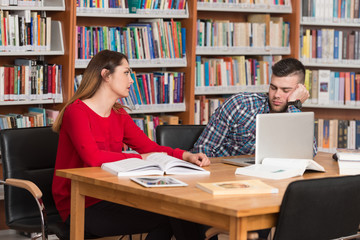 Stressed Students Doing Their Homework At The Desk