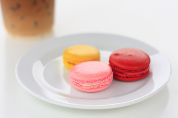 Sweet and colourful french macarons on white table