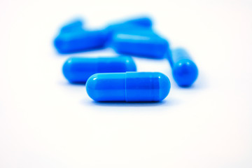 blue capsules on a white background