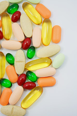 Many colorful pills on white background