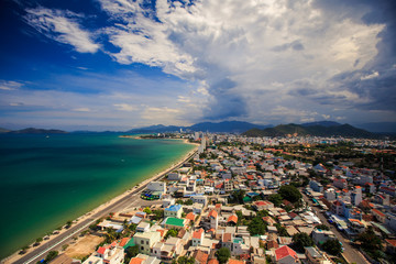 Fototapeta premium upper view of resort city near azure sea with long beach highway