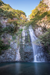 Obraz premium Mino Falls Meiji-no-mori Mino Quasi-national Park (Mino Waterfall) Minoo Park Stream - take photo in early autumn season before red maple grown 