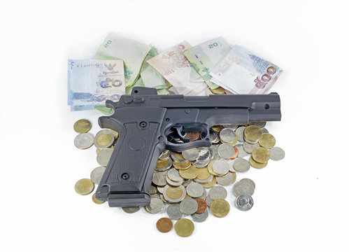 handgun on thai money banknotes and coins