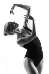 Fototapeta premium Modern ballet dancer posing on white background