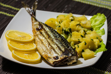 Grilled mackerel with potato salad and lemon