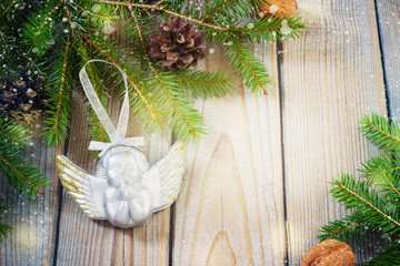 toys for the Christmas tree and pine cones on old wooden background