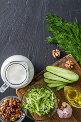 Tarator ingredients on dark stone background