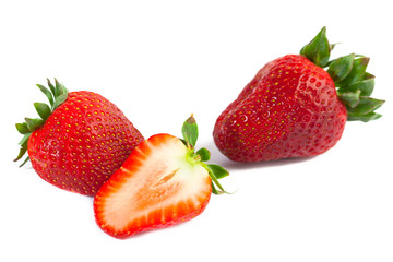 big red juicy rich strawberries with pedicle on white backgrond
