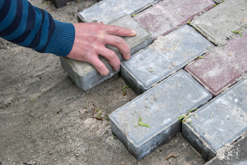 Installing paver bricks for the sidewalk pavement