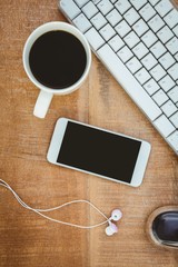Obraz na płótnie Canvas Coffee and white smartphone with headphones