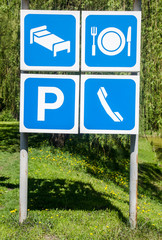 Sign for  parking lot against summer tree