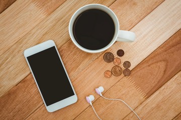Obraz na płótnie Canvas Coffee and white smartphone with white headphones