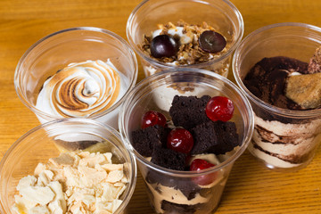 Creamy dessert in plastic cup