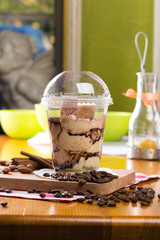 Creamy dessert in plastic cup