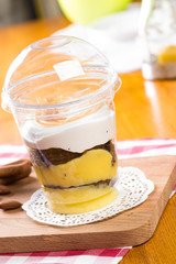 Creamy dessert in plastic cup