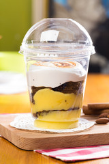 Creamy dessert in plastic cup