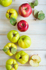 apples and quinces on plank background