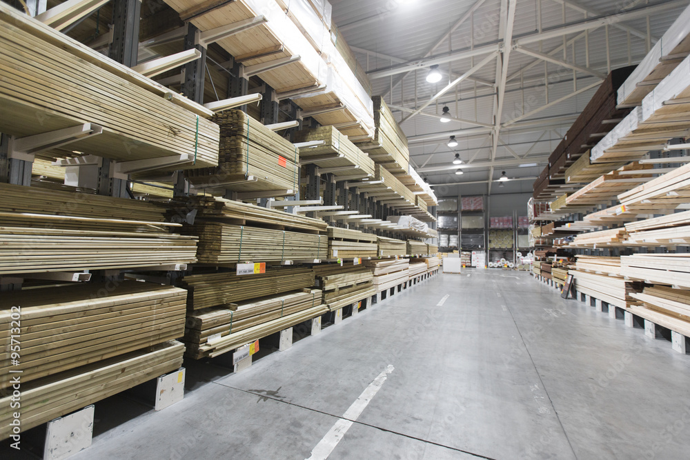 Wall mural warehouse with variety of timber for construction and repair