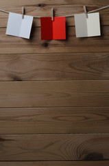 Three Opened Greetings Cards Pegged to String on Wood Planking