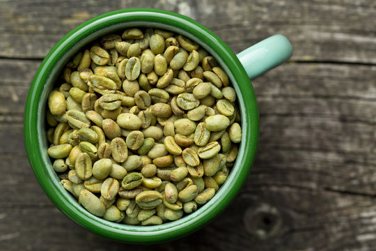 unroasted coffee beans in mug